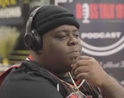 Podcast interview image related to BigXthaPlug, a rapper wearing headphones.