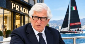 Patrizio Bertelli in a suit outside a luxury fashion storefront